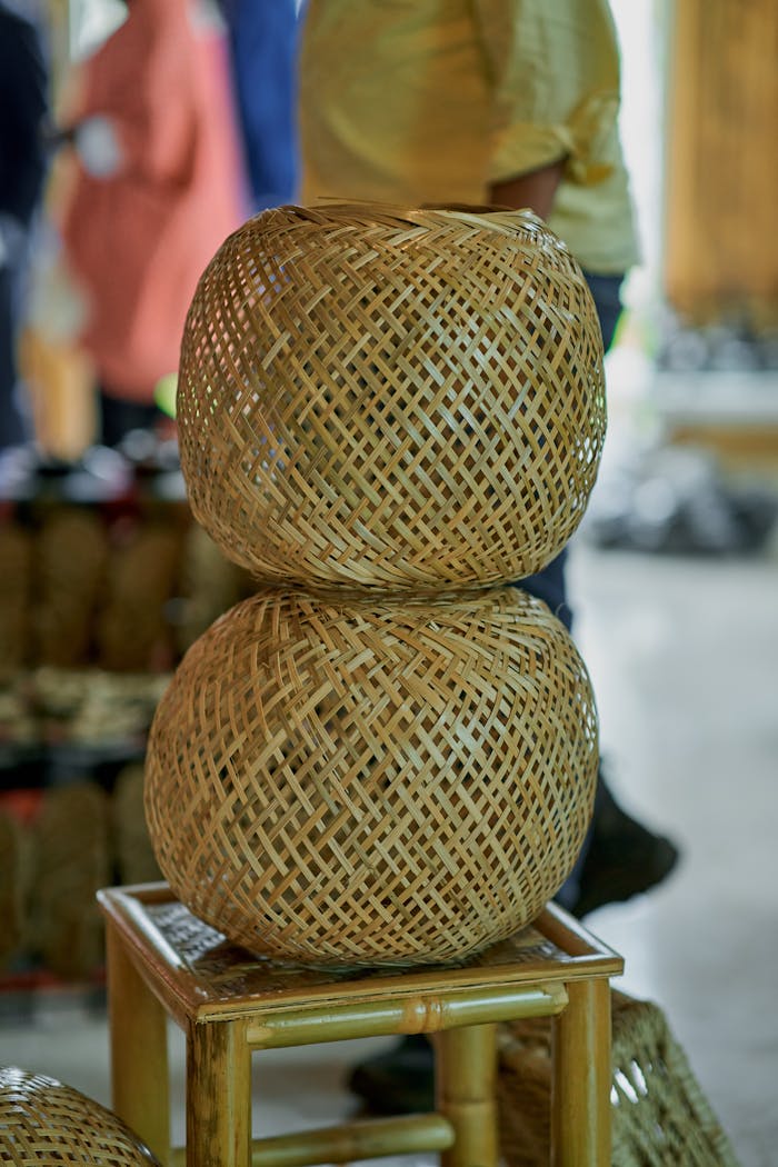 Services-03 Two stacked woven bamboo baskets displayed in a craft market setting.